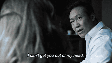 A man, looking at a woman, says, "I can't get you out of my head." Scene appears tense