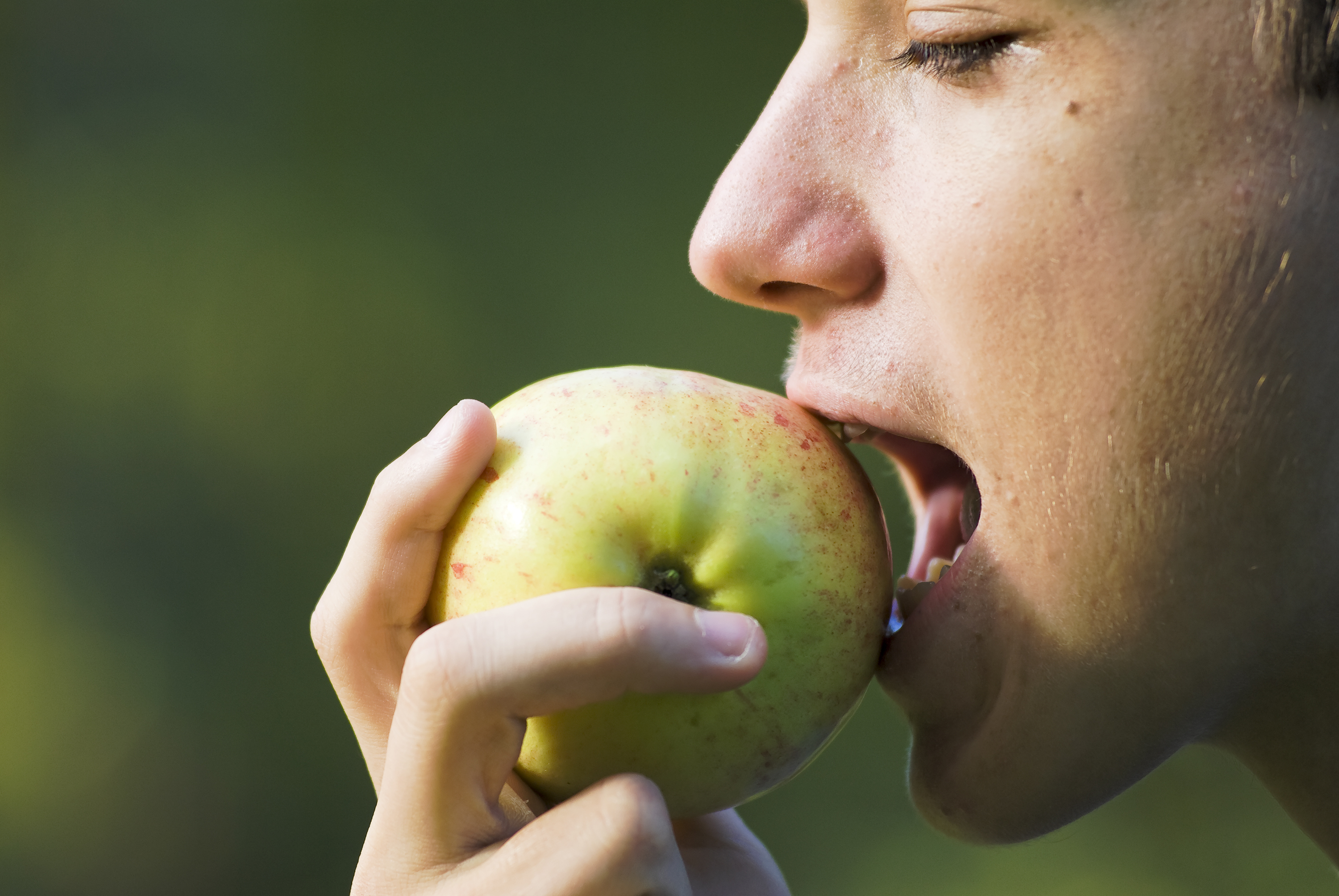 Person biting into an apple