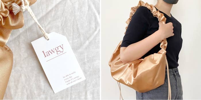 Person carrying a stylish, ruched bag. Close-up shows &quot;lawgy&quot; tag with small text: &quot;Be who u wish, create ur own destiny, live how u wanna live.&quot;