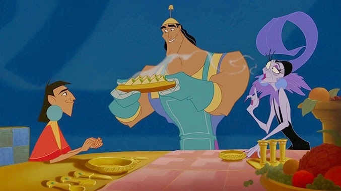 Kuzco, Kronk, and Yzma from The Emperor's New Groove at a dining table. Kronk, in a chef's apron and hat, serves food, while Kuzco and Yzma await the meal