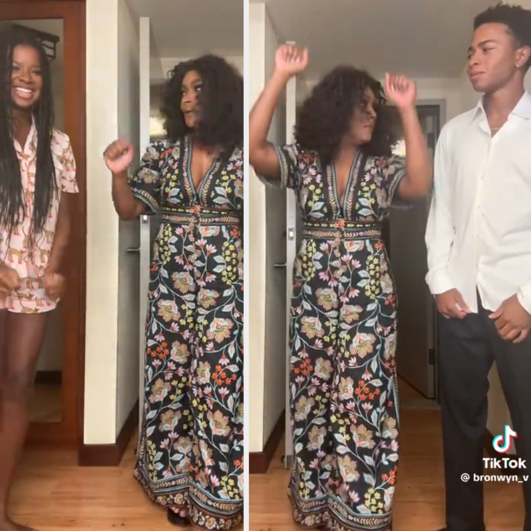 Three people dancing in a hallway. Bronwyn V-H on left wears pajamas. Middle and right individuals are posing; middle wears a floral jumpsuit, right in a white shirt