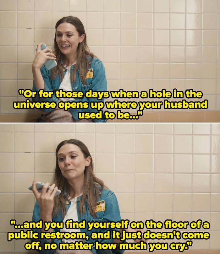 Elizabeth Olsen smiles and looks at her phone, seated against a tiled wall. She wears a denim jacket over a white top