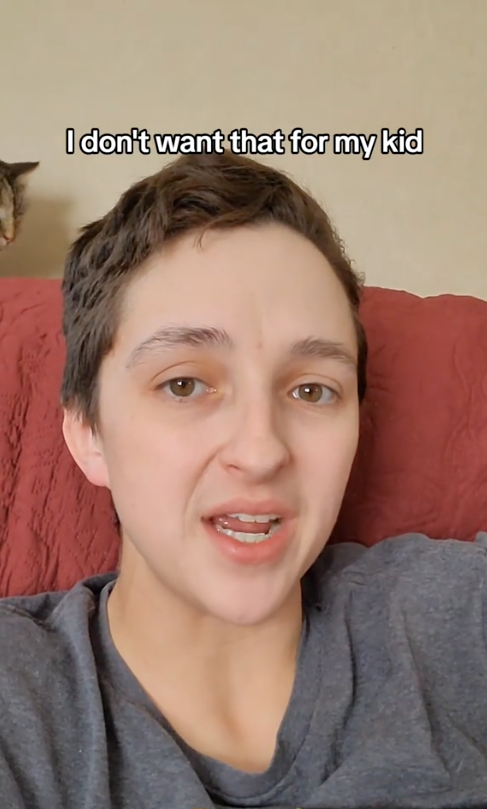 A person with short hair, wearing a casual shirt, speaks with the caption "I don't want that for my kid." A cat is visible in the background