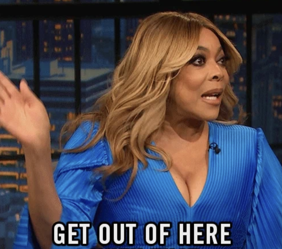 Wendy Williams, in a blue dress, gestures with a surprised expression on a talk show set, captioned &quot;GET OUT OF HERE.&quot;