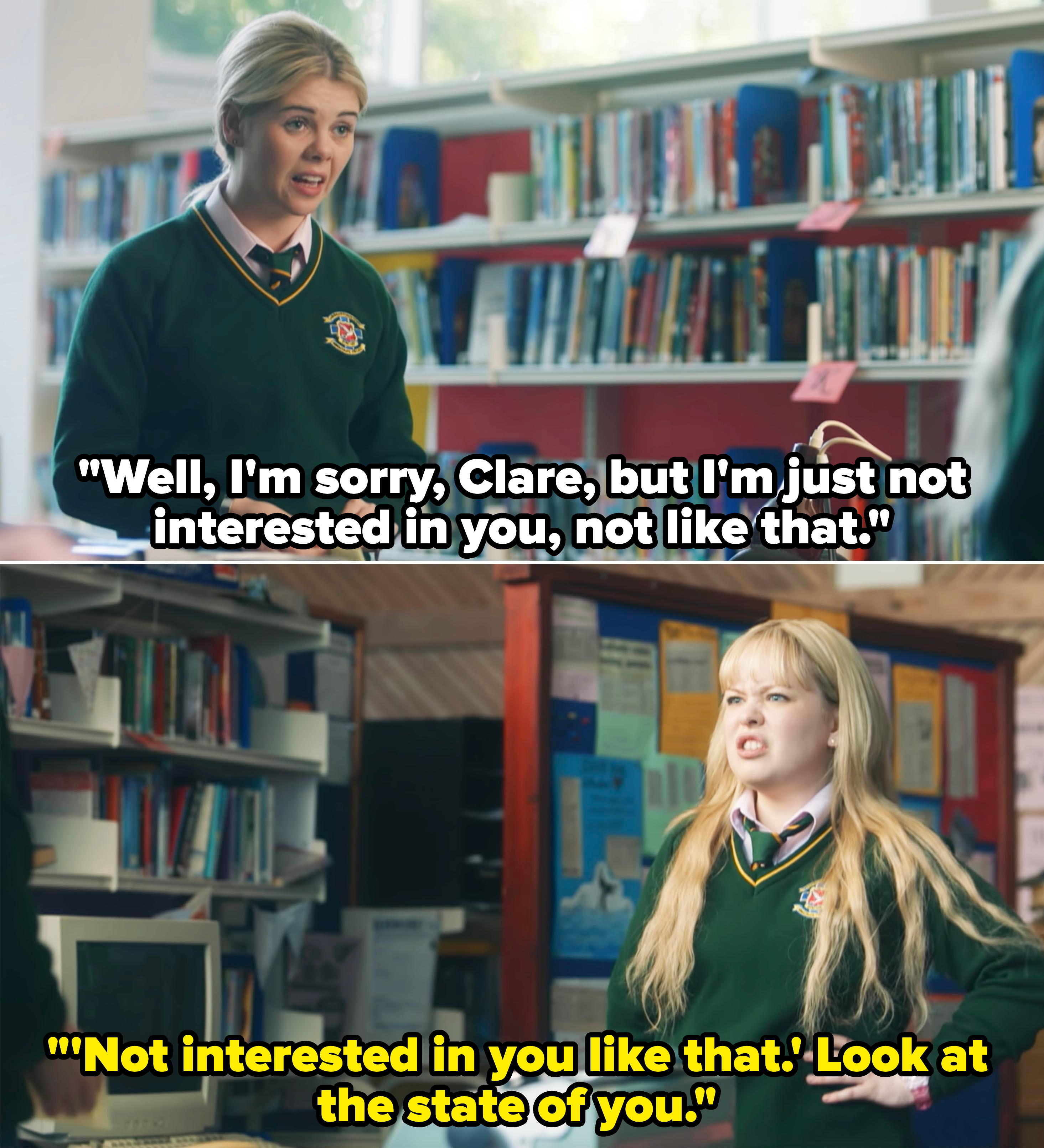 Nicola Coughlan, in a school uniform, standing and talking in a library with shelves of books behind her, speaking to someone off-camera