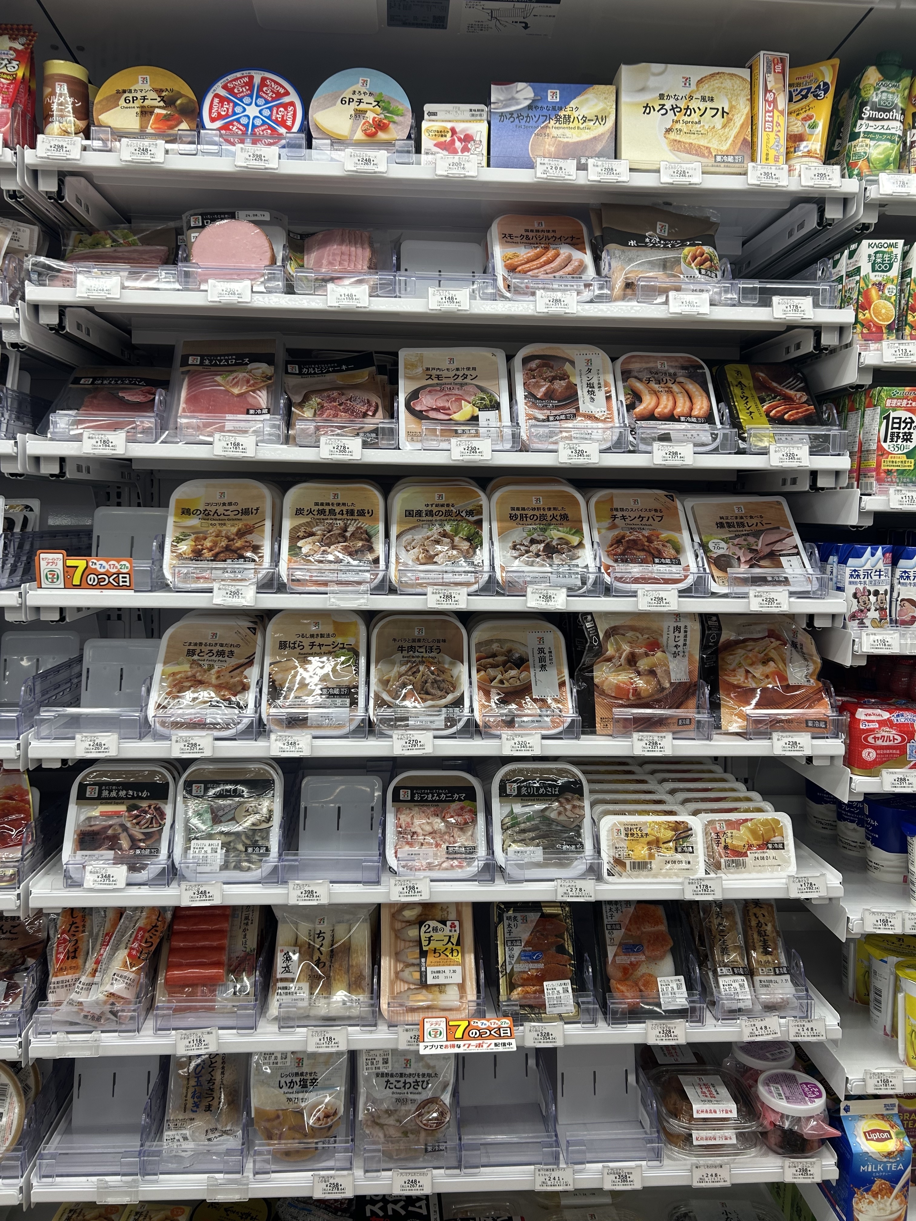 Store shelf stocked with a variety of packaged foods including meats, ready-to-eat meals, and snacks