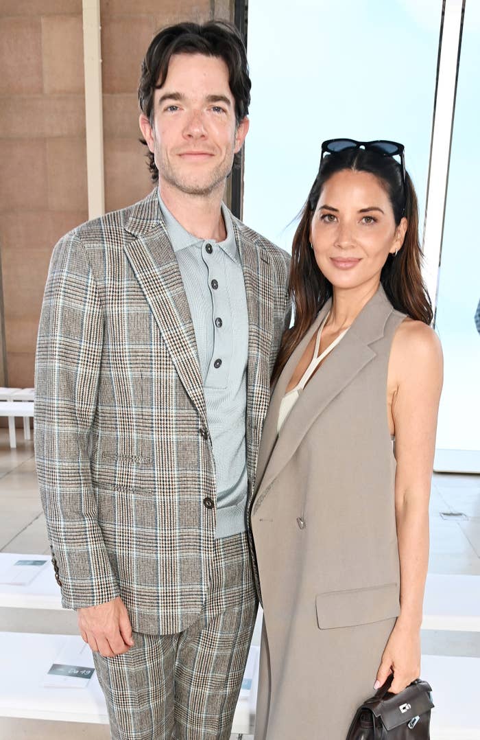 John Mulaney in a plaid suit and Olivia Munn in a beige vest dress attend an event together