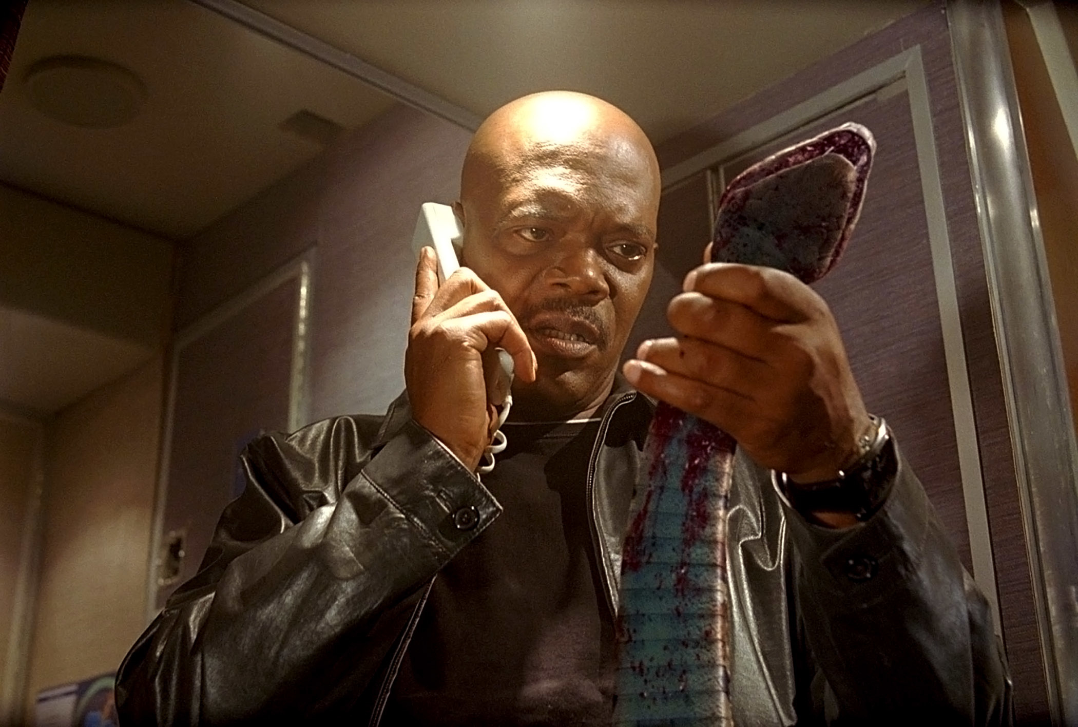 Samuel L. Jackson holding a snake and talking on the phone in &quot;Snakes on a Plane&quot;