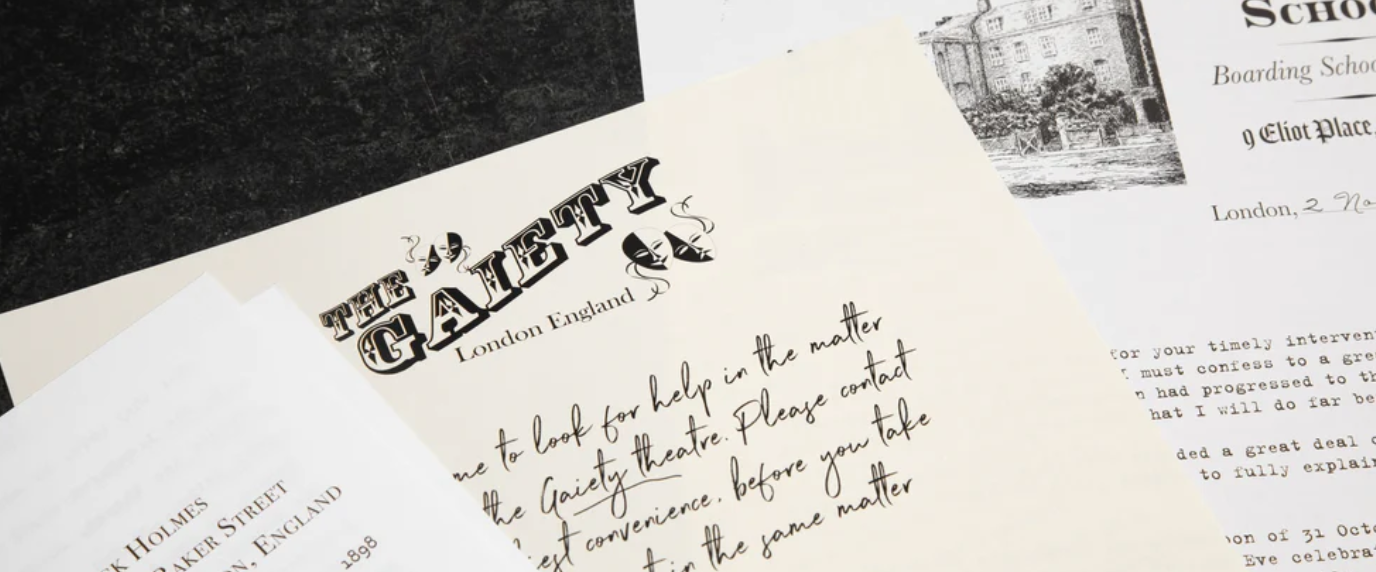 Scattered collection of vintage papers including a letter from "The Gaiety" theater in London and a boarding school's document