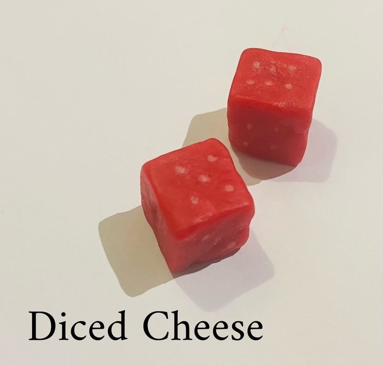 Two red dice with white dots are labeled as &quot;Diced Cheese&quot; in large black text below