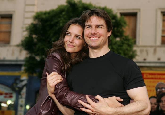 Katie Holmes and Tom Cruise embracing each other and smiling outdoors