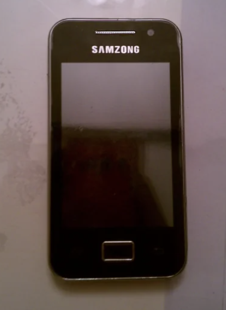 A mobile phone with the label "SAMZONG" on the top of the device. It features a touch screen and a single physical button below the screen