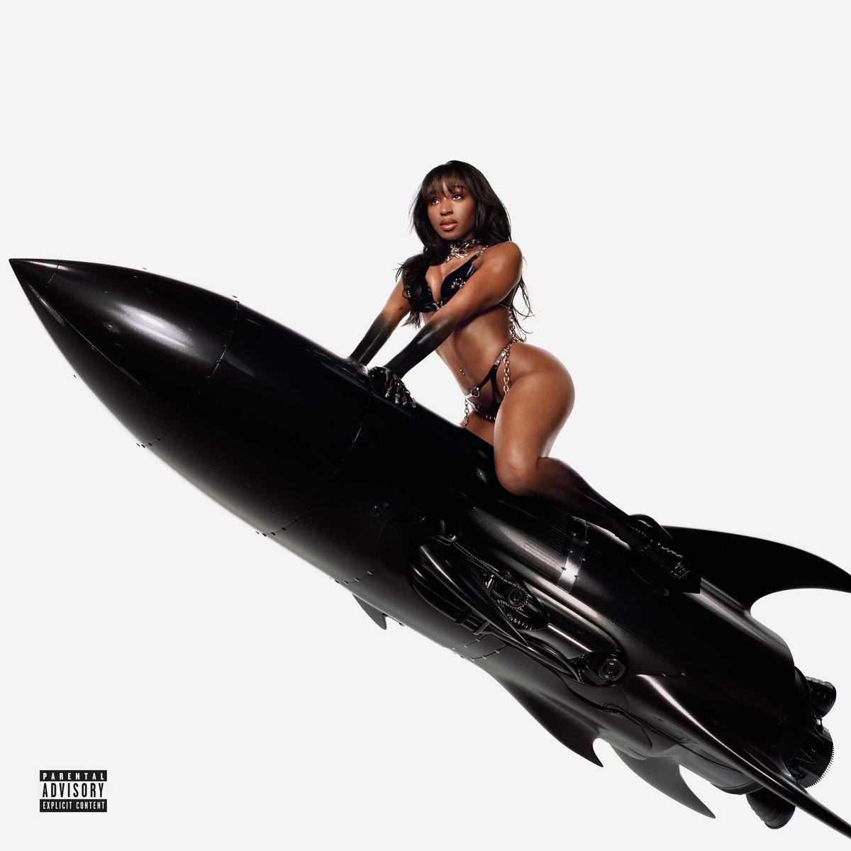 Normani poses in dark leather lingerie on a rocket-shaped object