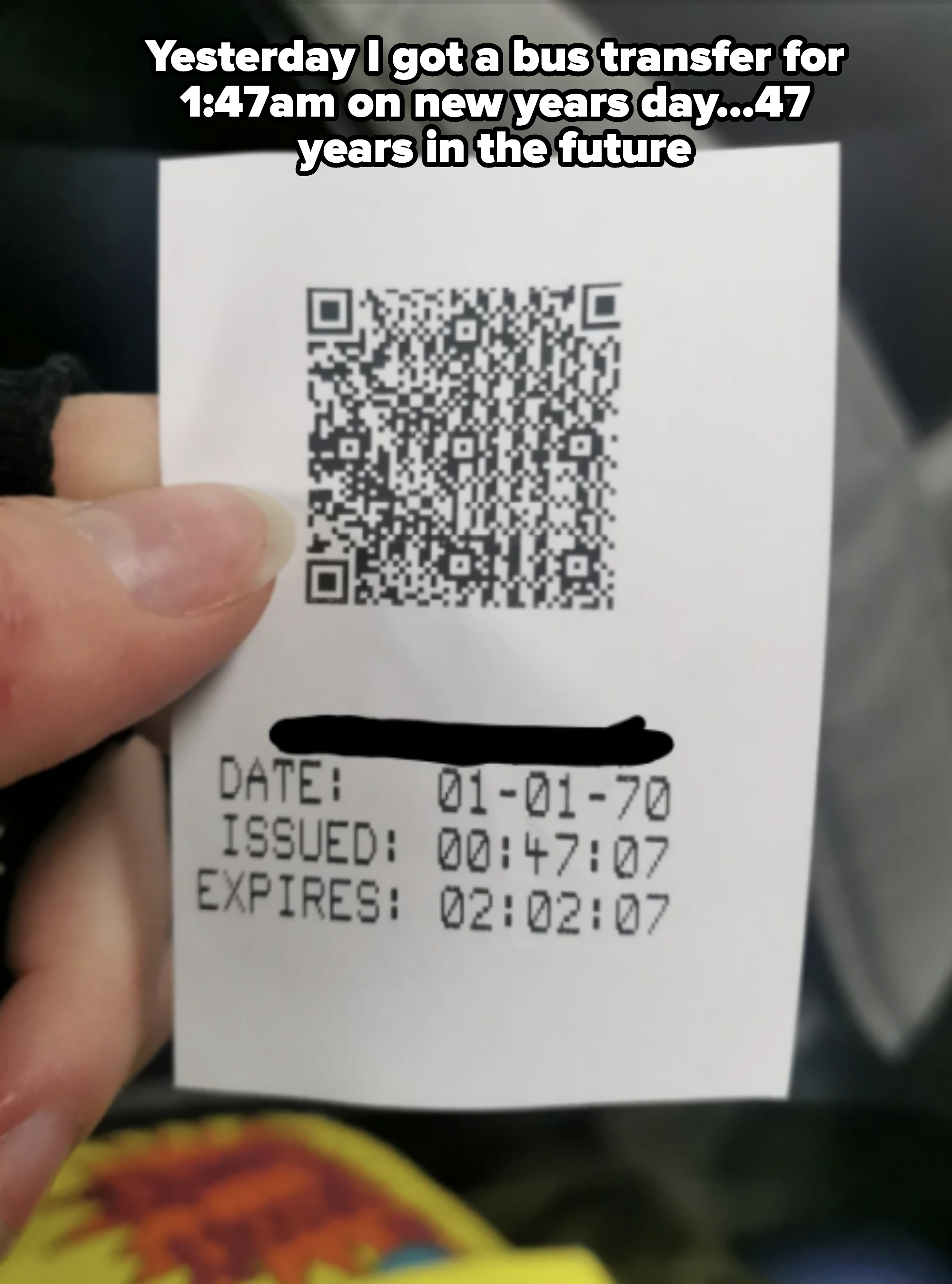 Close-up of a hand holding an official ticket with a QR code. Text on the ticket shows dates and times for issued and expiration periods
