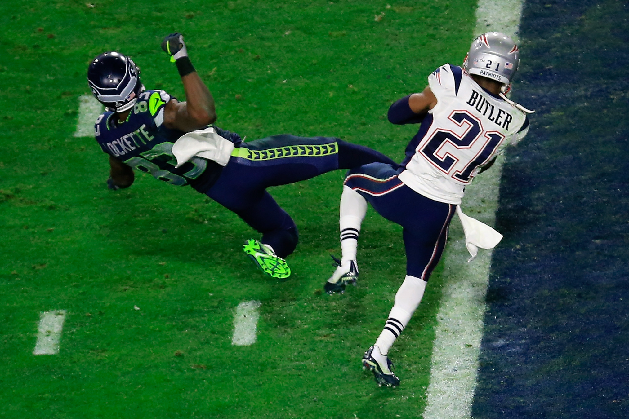 Ricardo Lockette of the Seahawks falling as Malcolm Butler of the Patriots intercepts the football during the Super Bowl