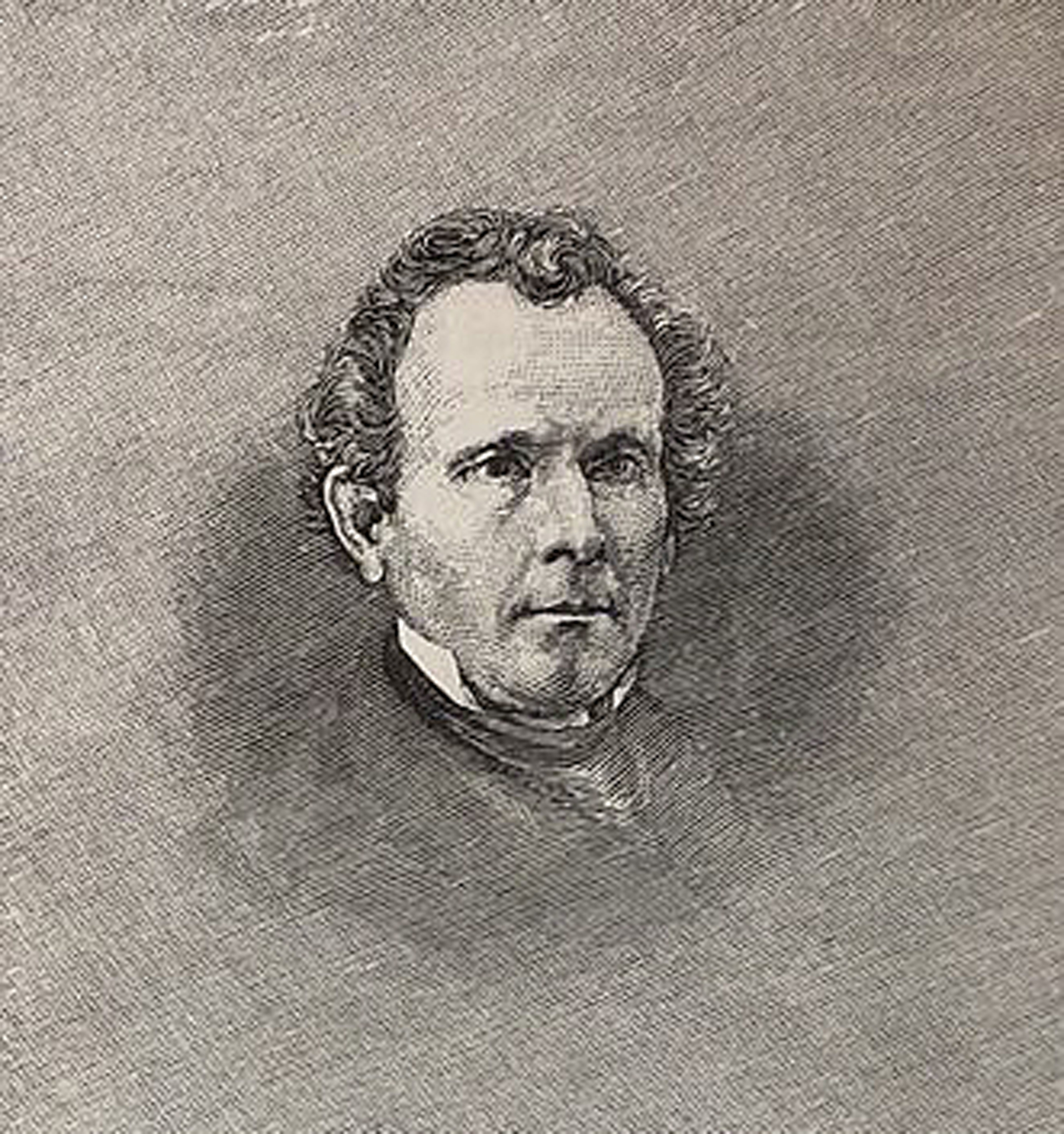 Portrait of a man with curly hair and a serious expression, wearing a formal suit