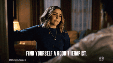 Mae Whitman as Annie Marks in a Good Girls scene, pointing with the text &quot;Find yourself a good therapist&quot; at the bottom