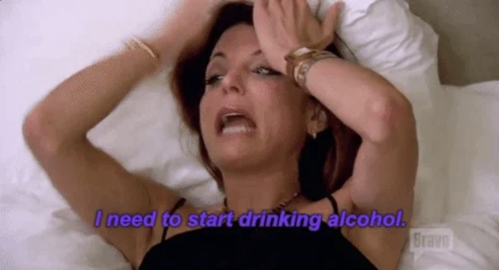 Bethenny Frankel lying on a bed with hands on her head, caption reads: "I need to start drinking alcohol."