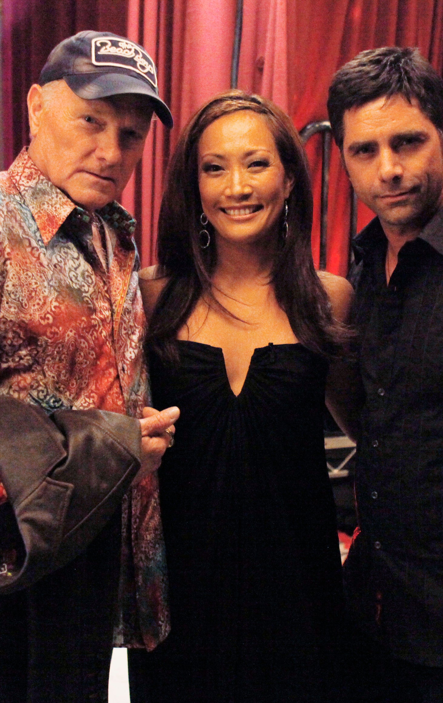 Carrie and John posing together backstage with arms around each other