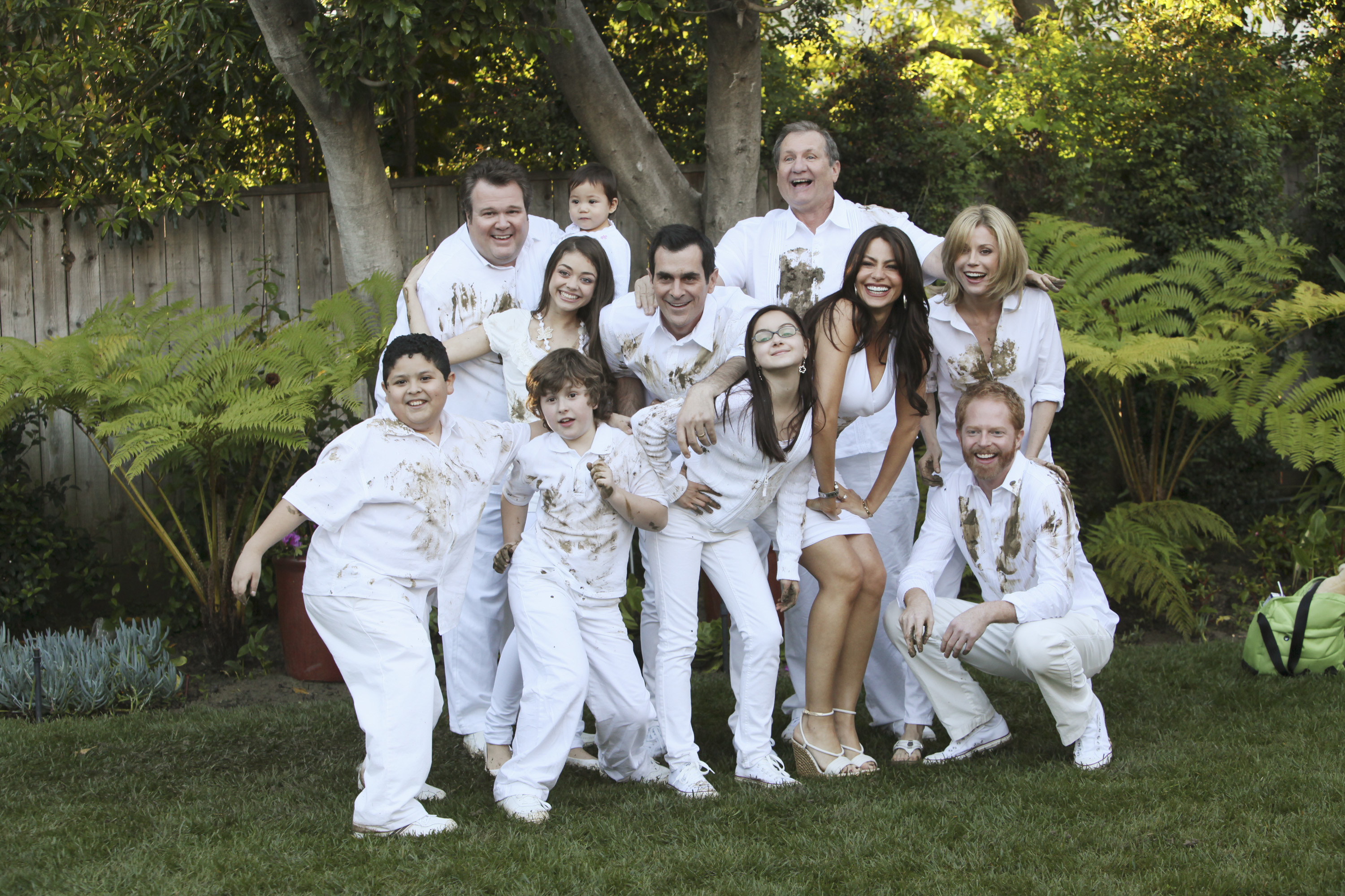 Scene from "Modern Family" TV show: Eric Stonestreet, Aubrey Anderson-Emmons, Nolan Gould, Sarah Hyland, Ty Burrell, Reid Ewing, Ariel Winter, Ed O'Neill, Sofia Vergara, Julie Bowen, Jesse Tyler Ferguson in dirty white clothing