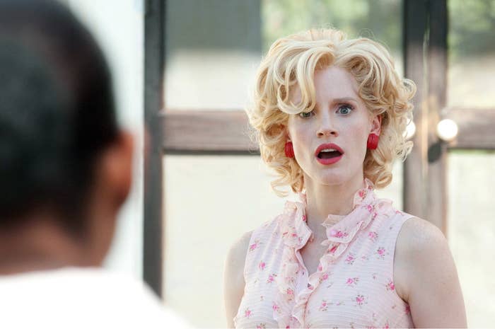 Jessica Chastain, wearing a ruffled sleeveless top, looks surprised or shocked in a scene from "The Help"