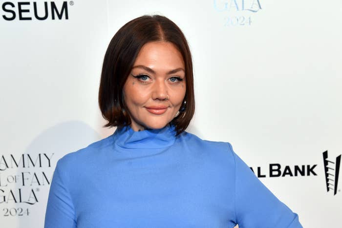 Elle King poses in a high-neck, long-sleeve dress with fringe details at Grammy Museum event