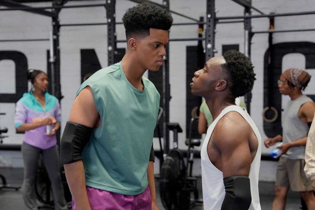 Jabari Banks and Olly Sholotan face off in a gym scene from &quot;Bel-Air.&quot; Jabari wears a sleeveless top with elbow pads and Olly wears a tank top