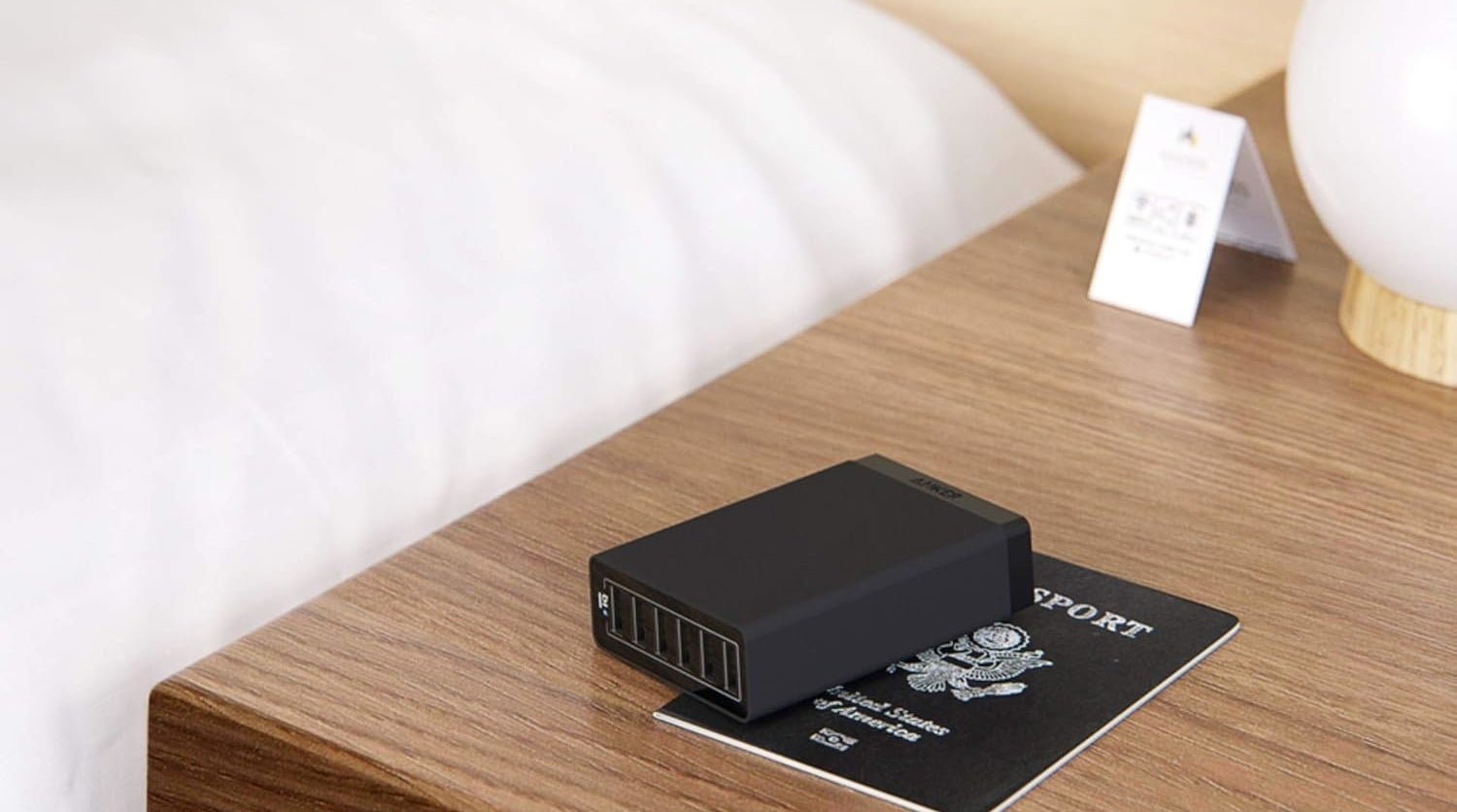 a charging port on top of a passport on a side table