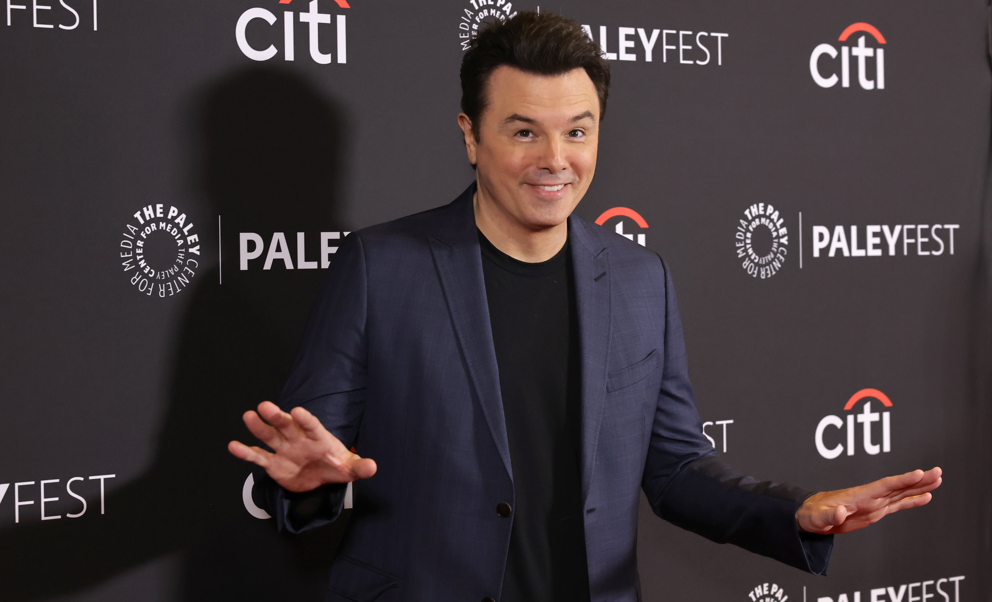 Seth MacFarlane at PaleyFest posing in a dark blazer and black shirt