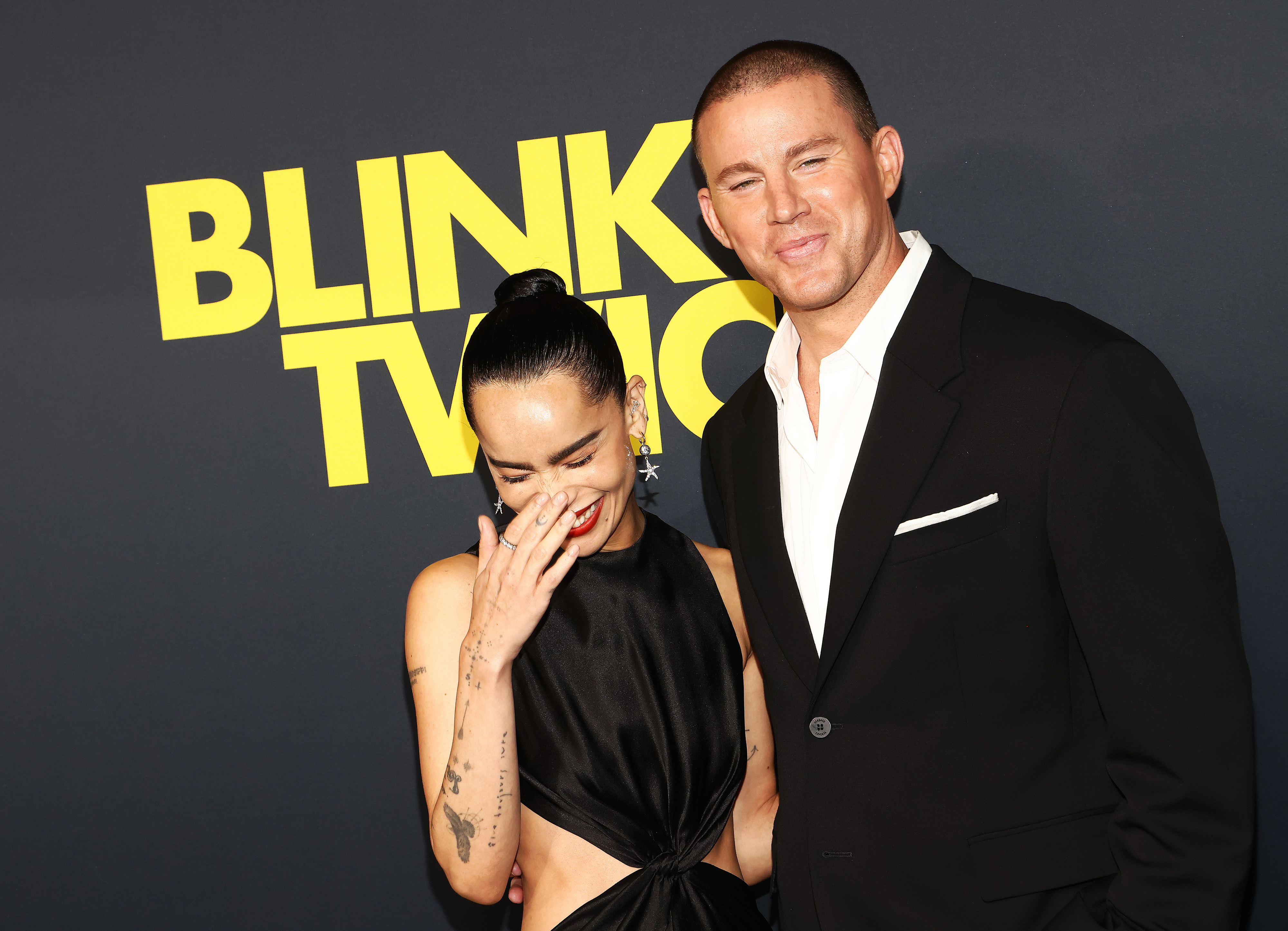 Zoë Kravitz and Channing Tatum pose together at a &quot;Blink Twice&quot; event. Zoë is wearing a sleeveless, cutout dress, and Channing is in a black suit
