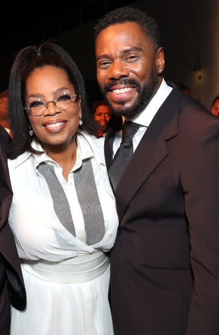 David Oyelowo, Oprah Winfrey, and Colman Domingo smile while posing together at an event, dressed in formal attire