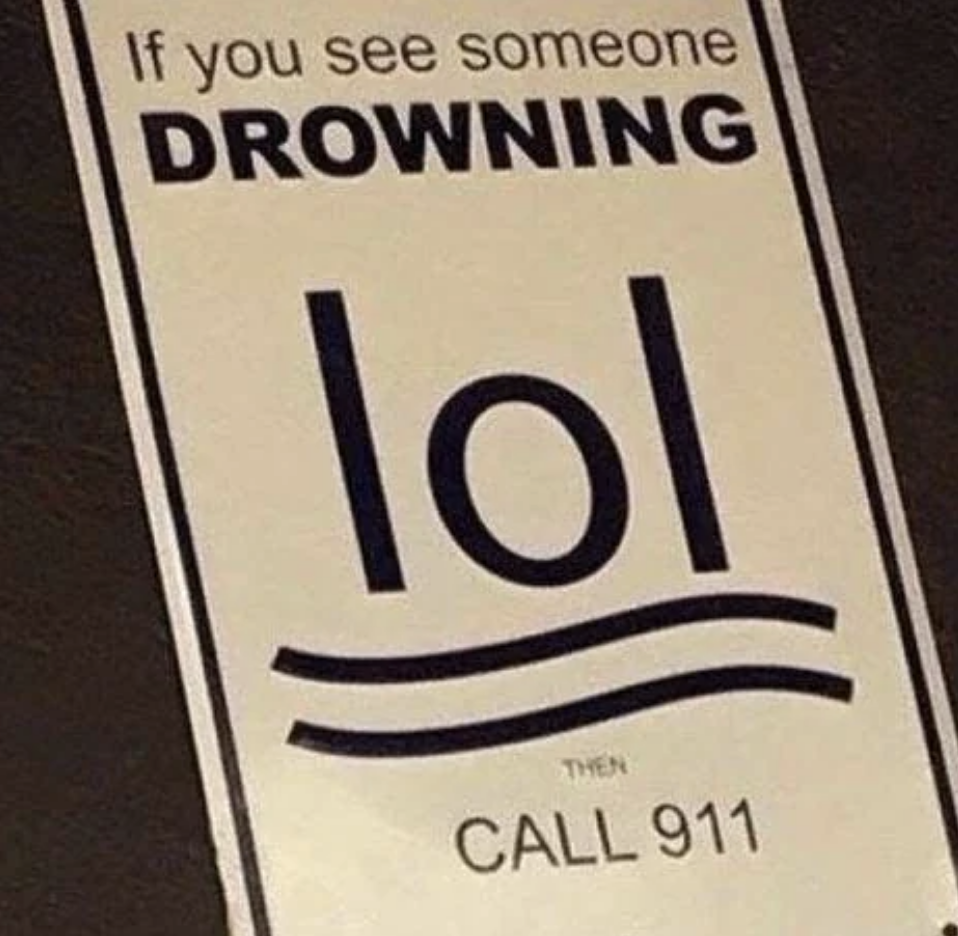 Sign with large text "If you see someone DROWNING lol," below a set of waves, then "CALL 911" in smaller text underneath
