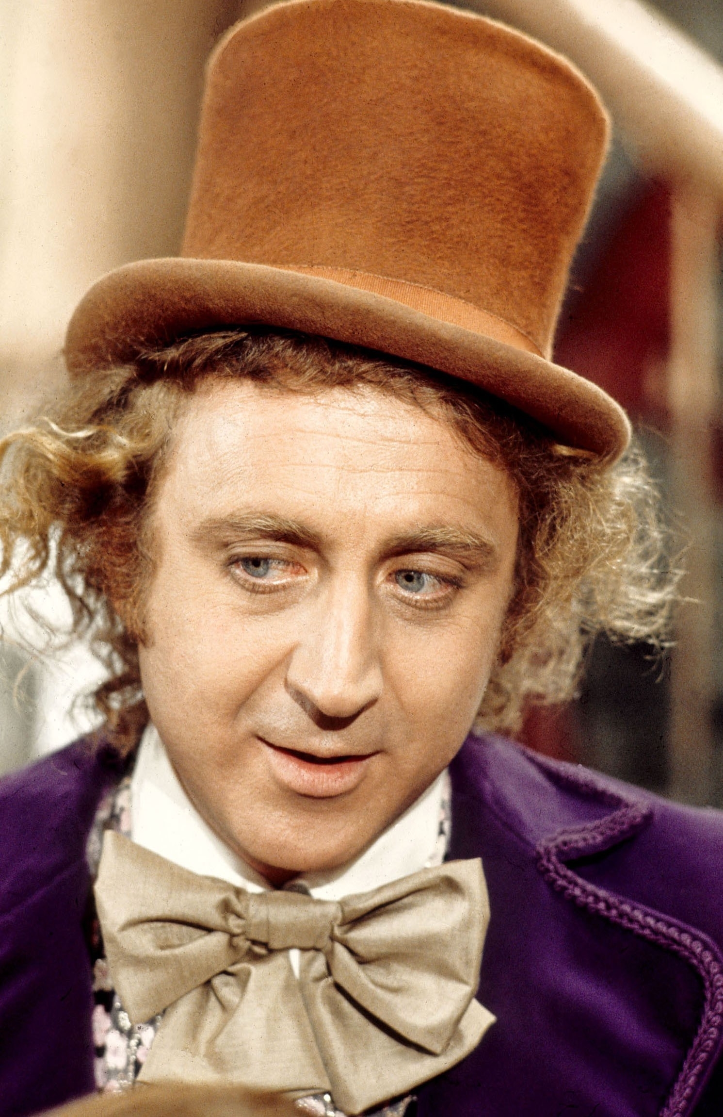 Gene Wilder as Willy Wonka, wearing a top hat and bow tie in a scene from the movie "Willy Wonka & the Chocolate Factory."