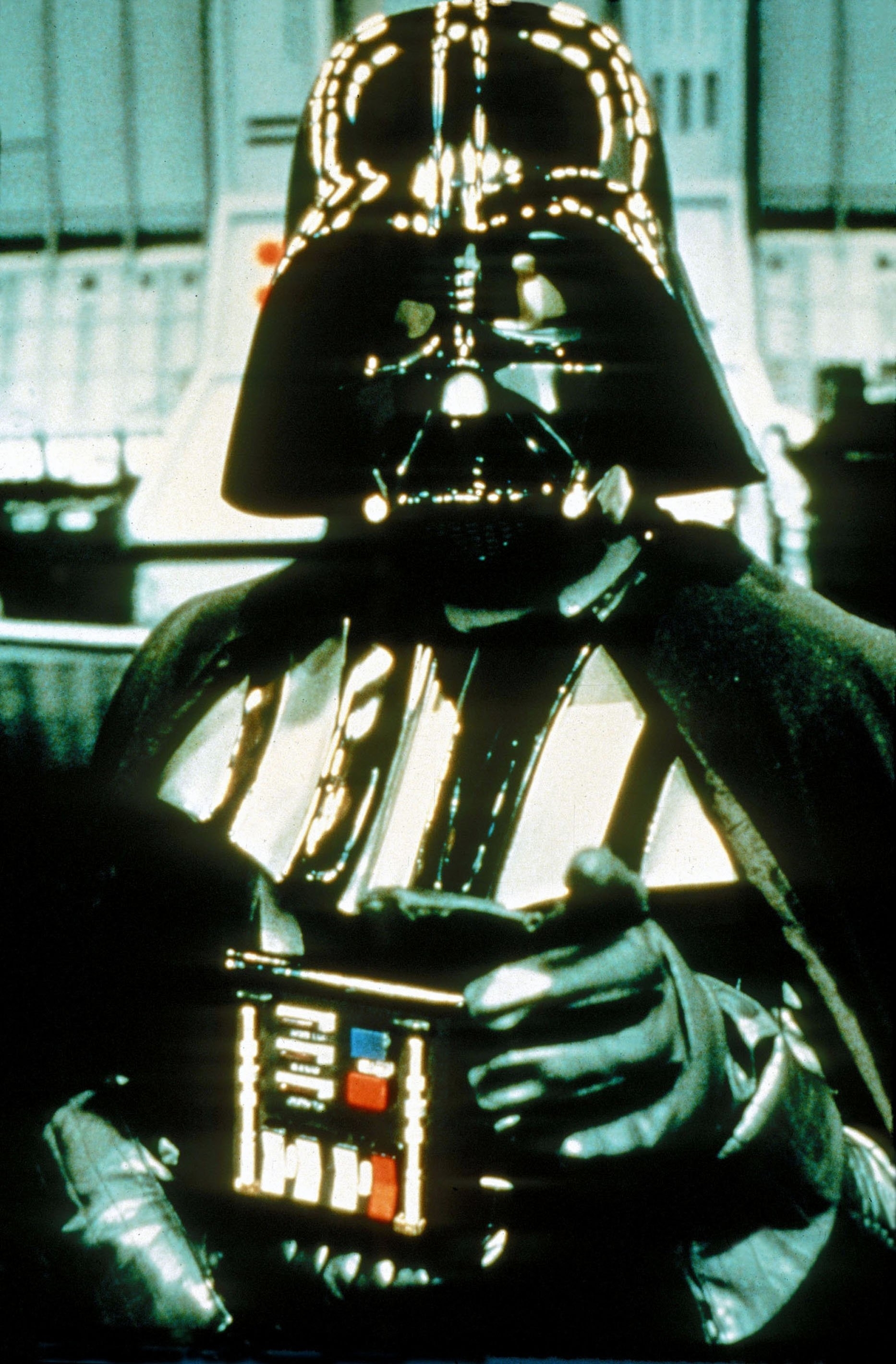 Darth Vader, a character from the Star Wars franchise, is seen in full costume pointing forward