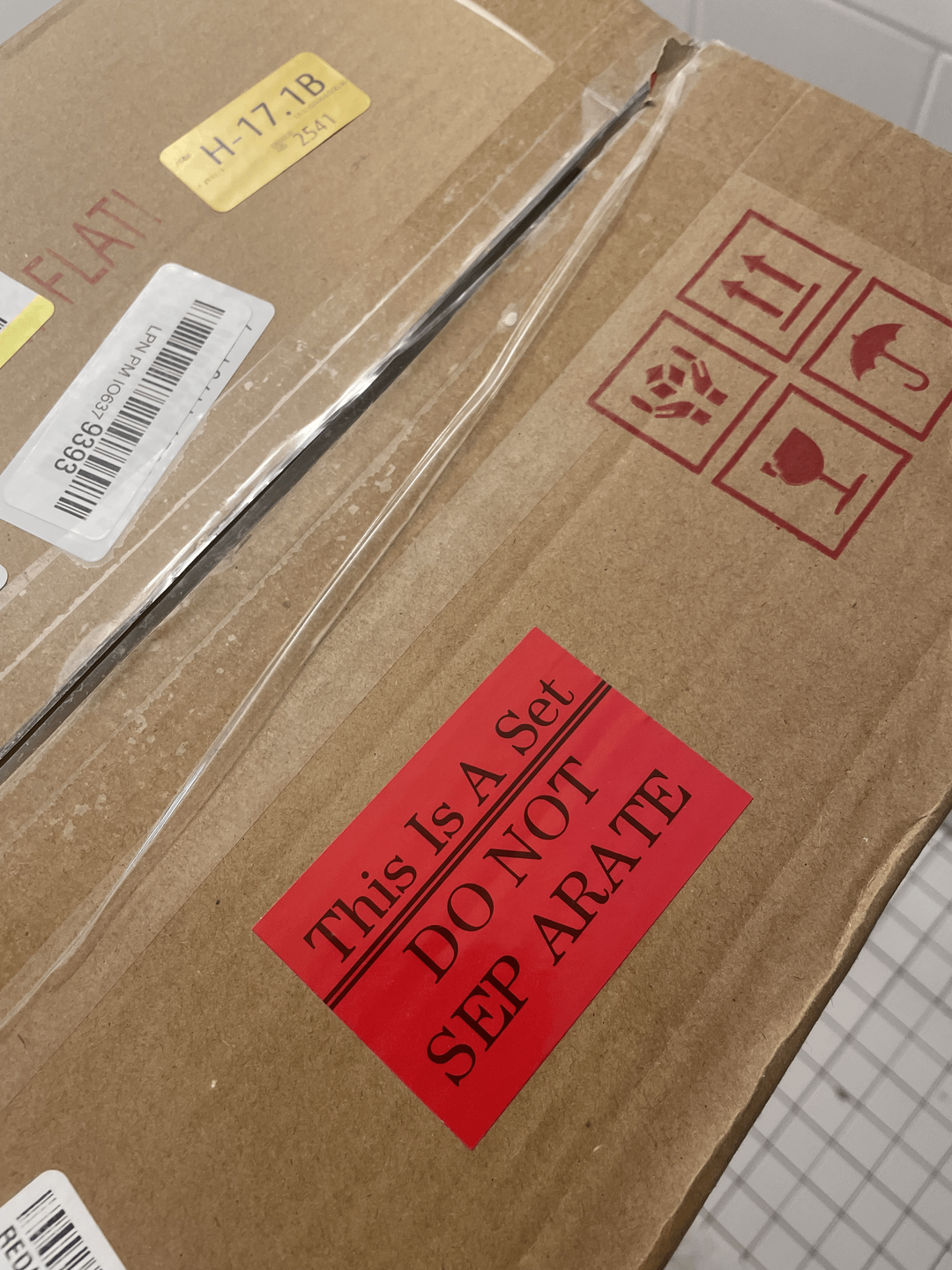 Two cardboard boxes with shipping labels and a red sticker reading, "This Is A Set. DO NOT SEPARATE" but the "sep" is separated from the "arate"
