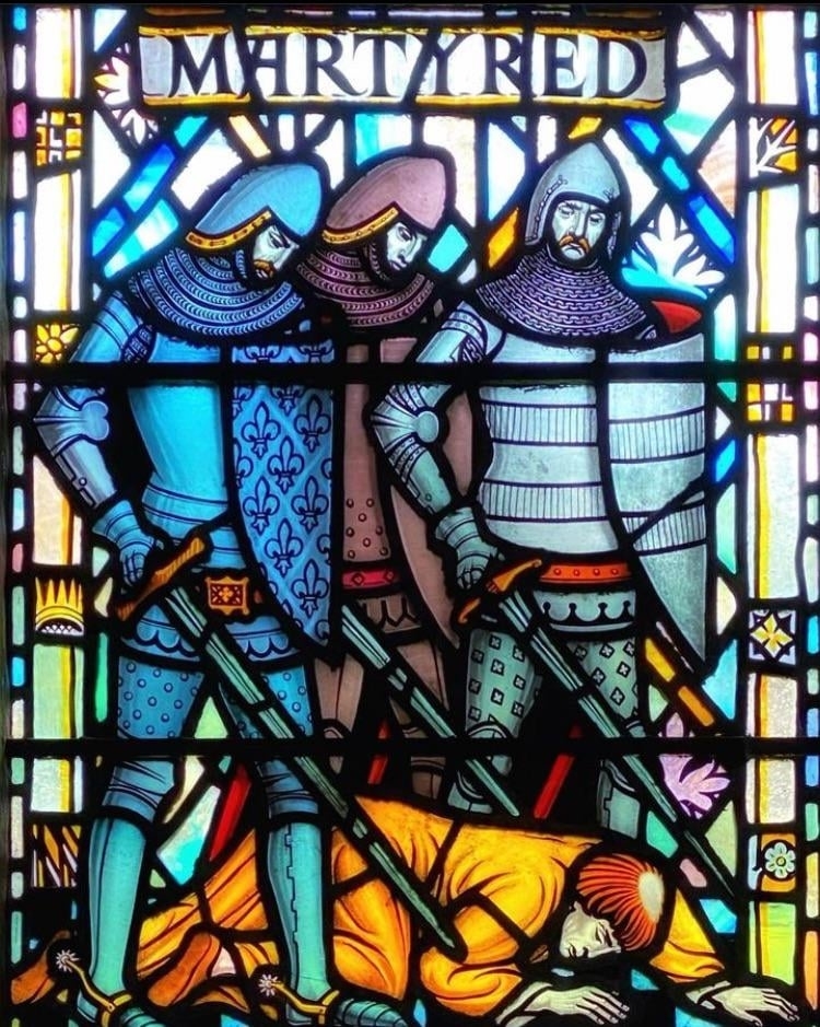 Stained glass depicts two knights standing over and killing a prone figure with a halo, labeled "Martyred" but the glass separates the word into "Marty red"