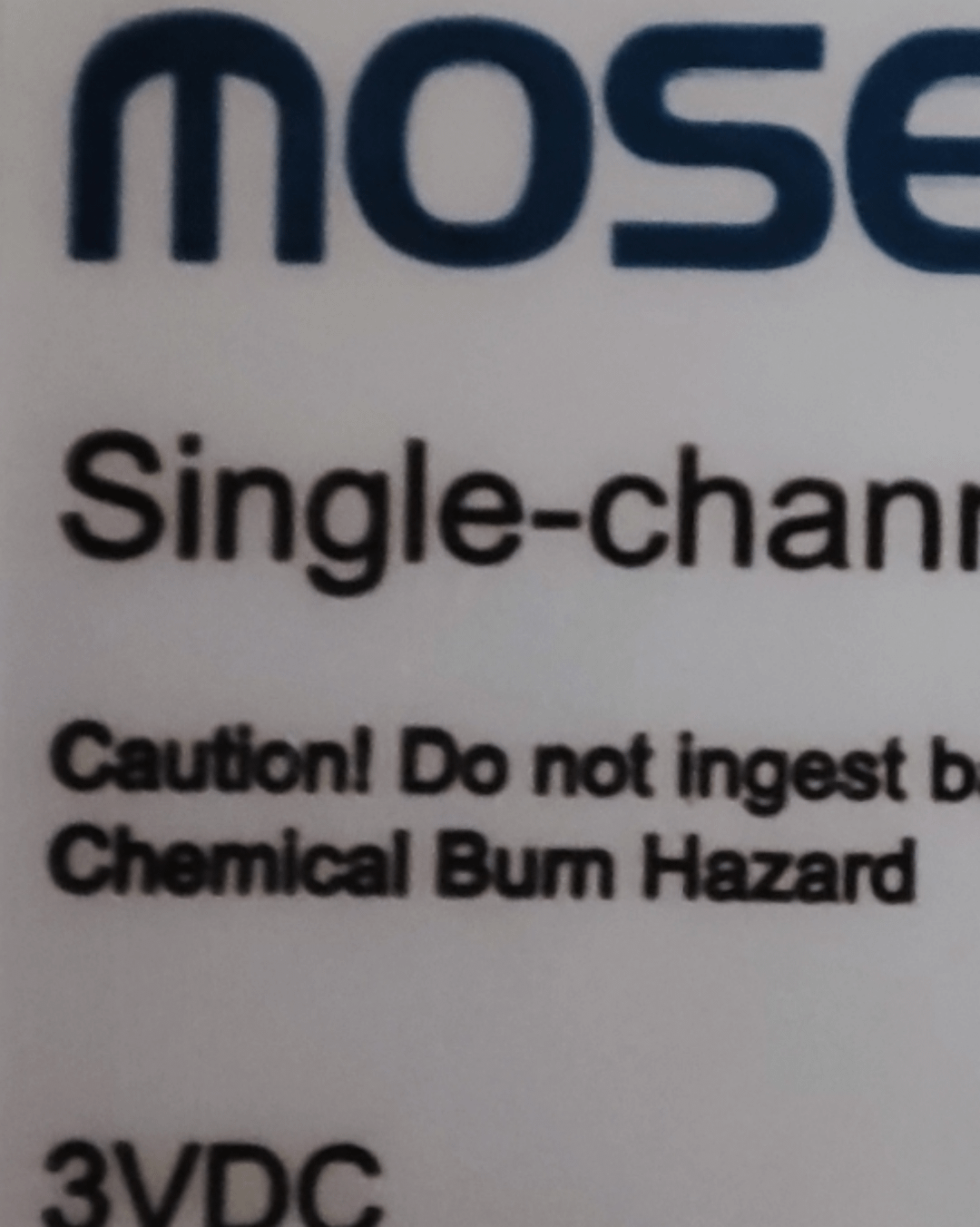 Close-up of product label reading "chemical burn hazard" but it looks like "chemical bum hazard"