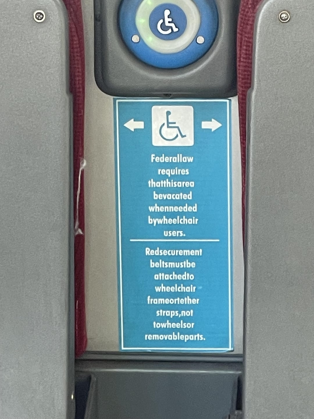 Sign on public transit indicating that the space must be made available for wheelchair users, but there is absolutely no spacing between any of the words