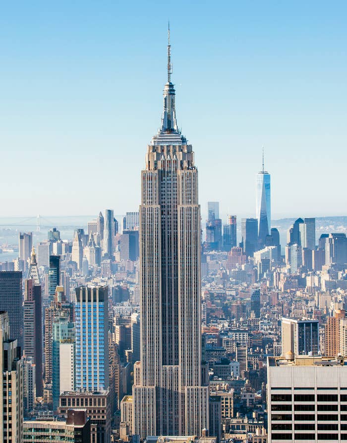 View of New York City skyline featuring the Empire State Building in the center, surrounded by various other skyscrapers