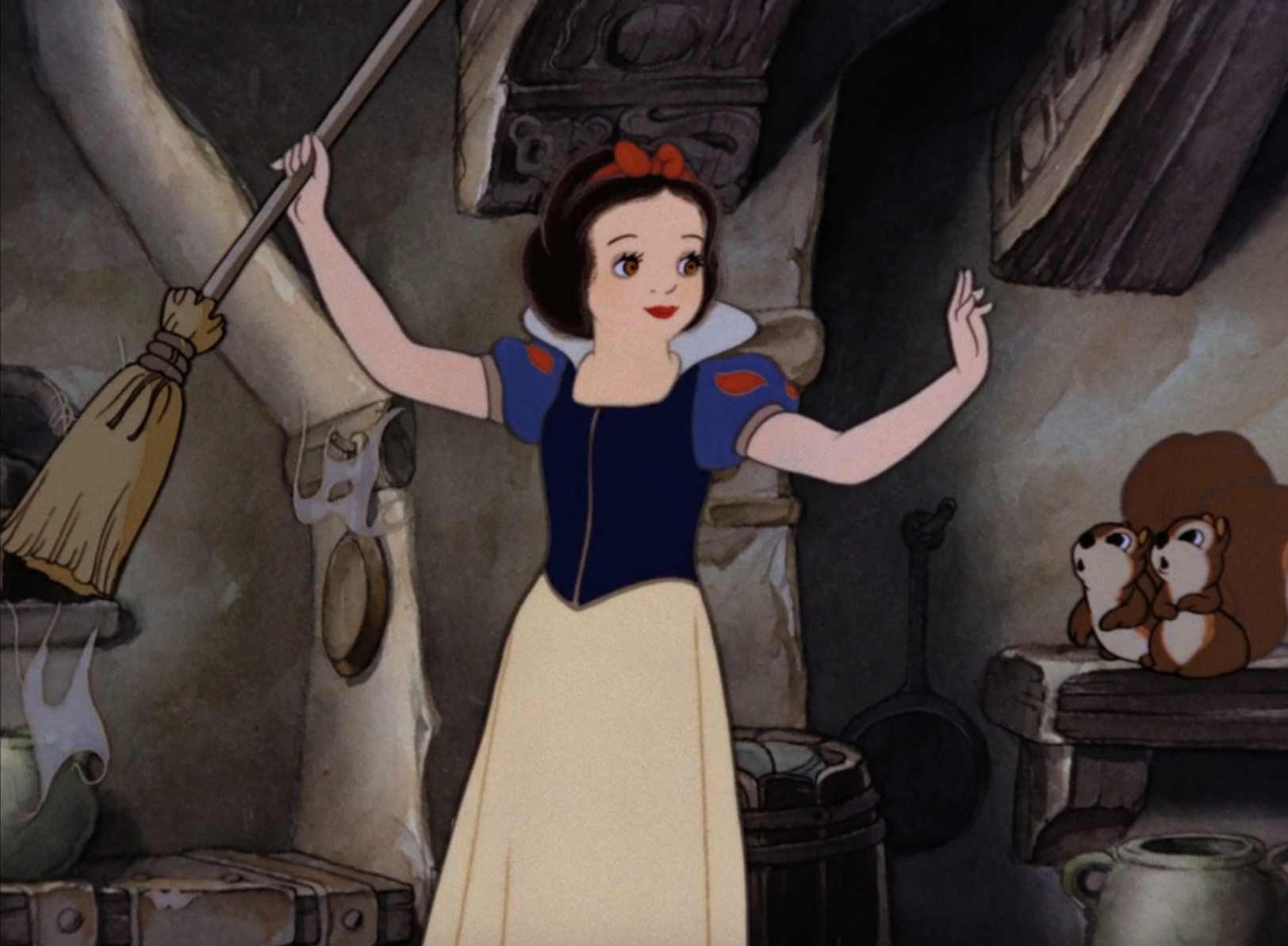 Snow White sweeping a cottage while gesturing towards two chipmunks on a table