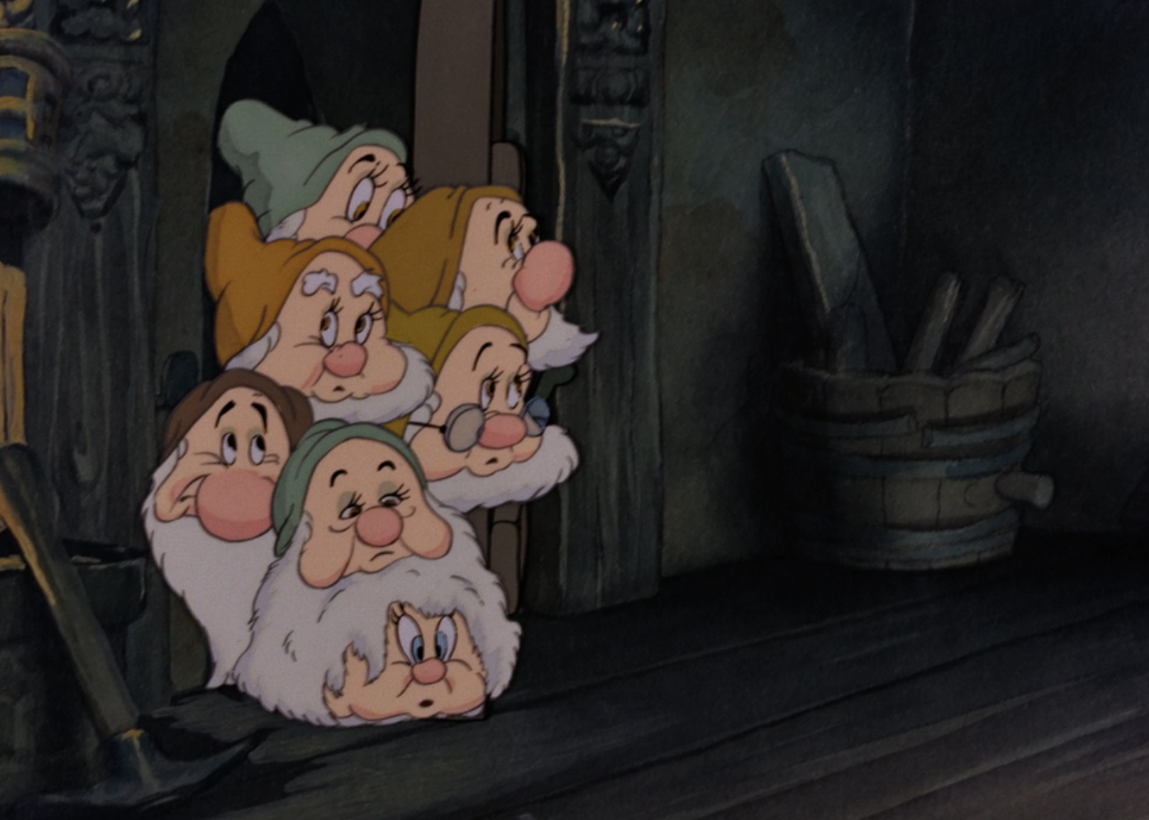 The Seven Dwarfs—Doc, Grumpy, Happy, Sleepy, Bashful, Sneezy, and Dopey—peek from behind a door in a scene from Snow White and the Seven Dwarfs