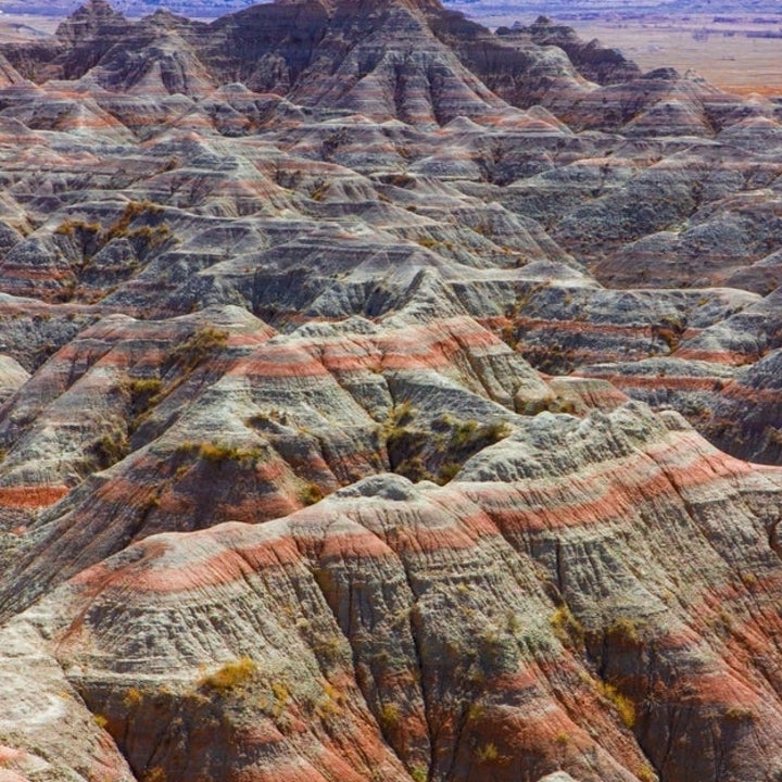 Aerial view of the rugged landscapes and layered rock formations of Badlands National Park