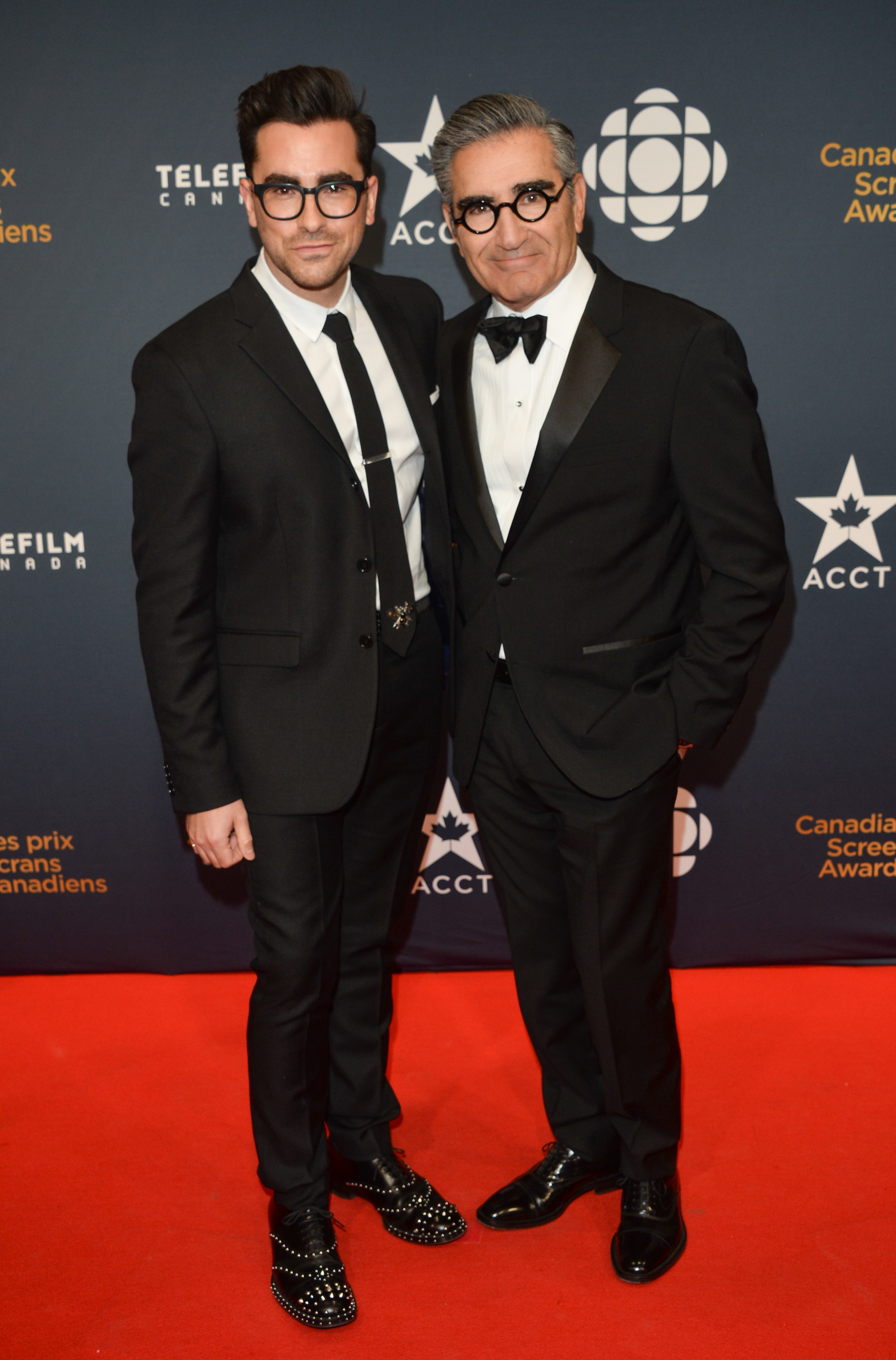 Dan Levy and Eugene Levy on the red carpet at the Canadian Screen Awards, both wearing black tuxedos