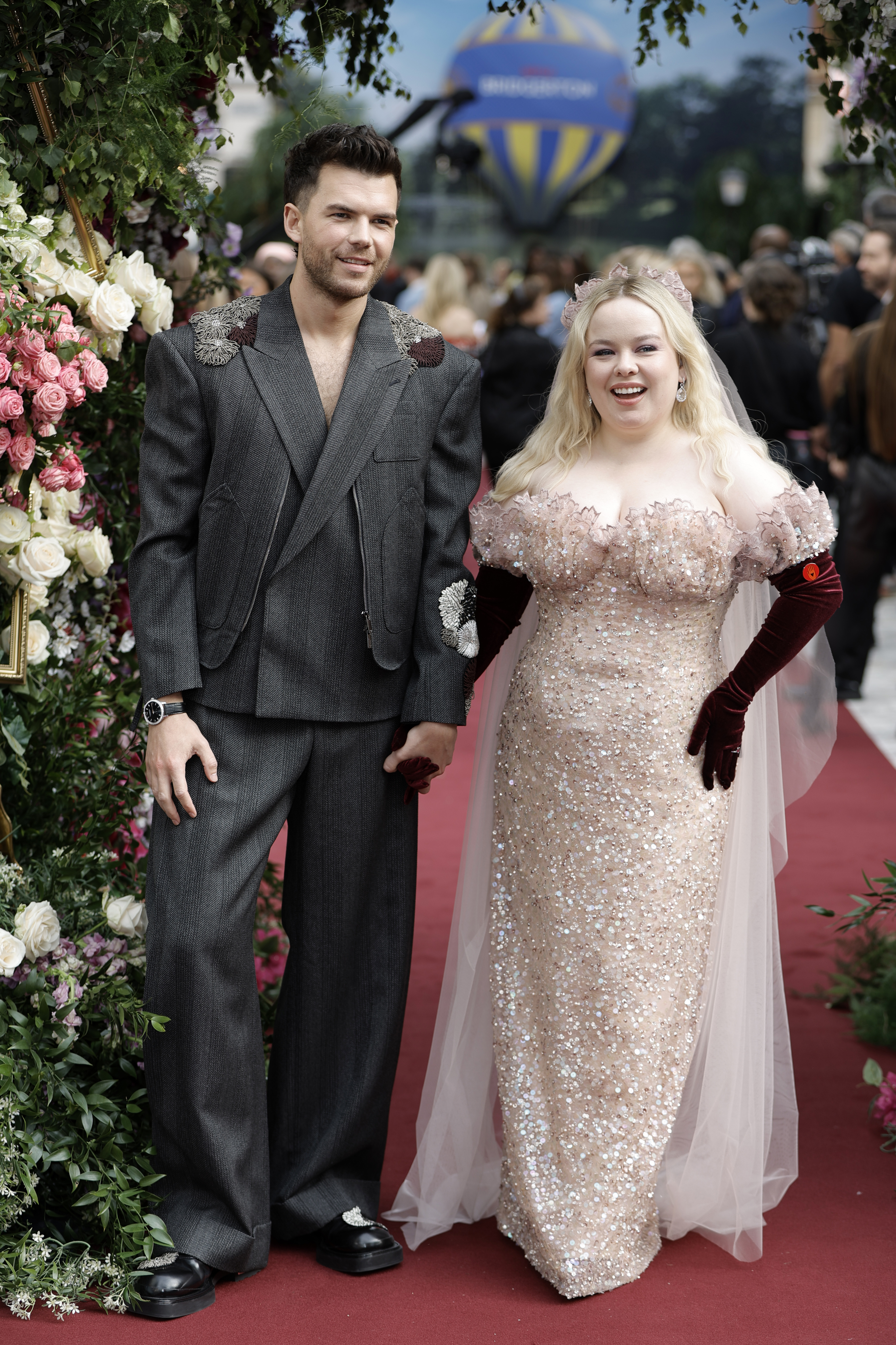 Nicola Coughlan and Luke Newton on the red carpet: Nicola in a sparkling, off-the-shoulder gown with velvet gloves, and Luke in a stylish, oversized suit
