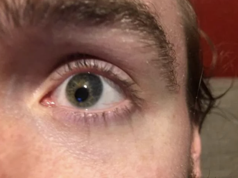 A close-up of a person's eye with visible details of the iris, eyelashes, and part of the eyebrow. No other notable context is present