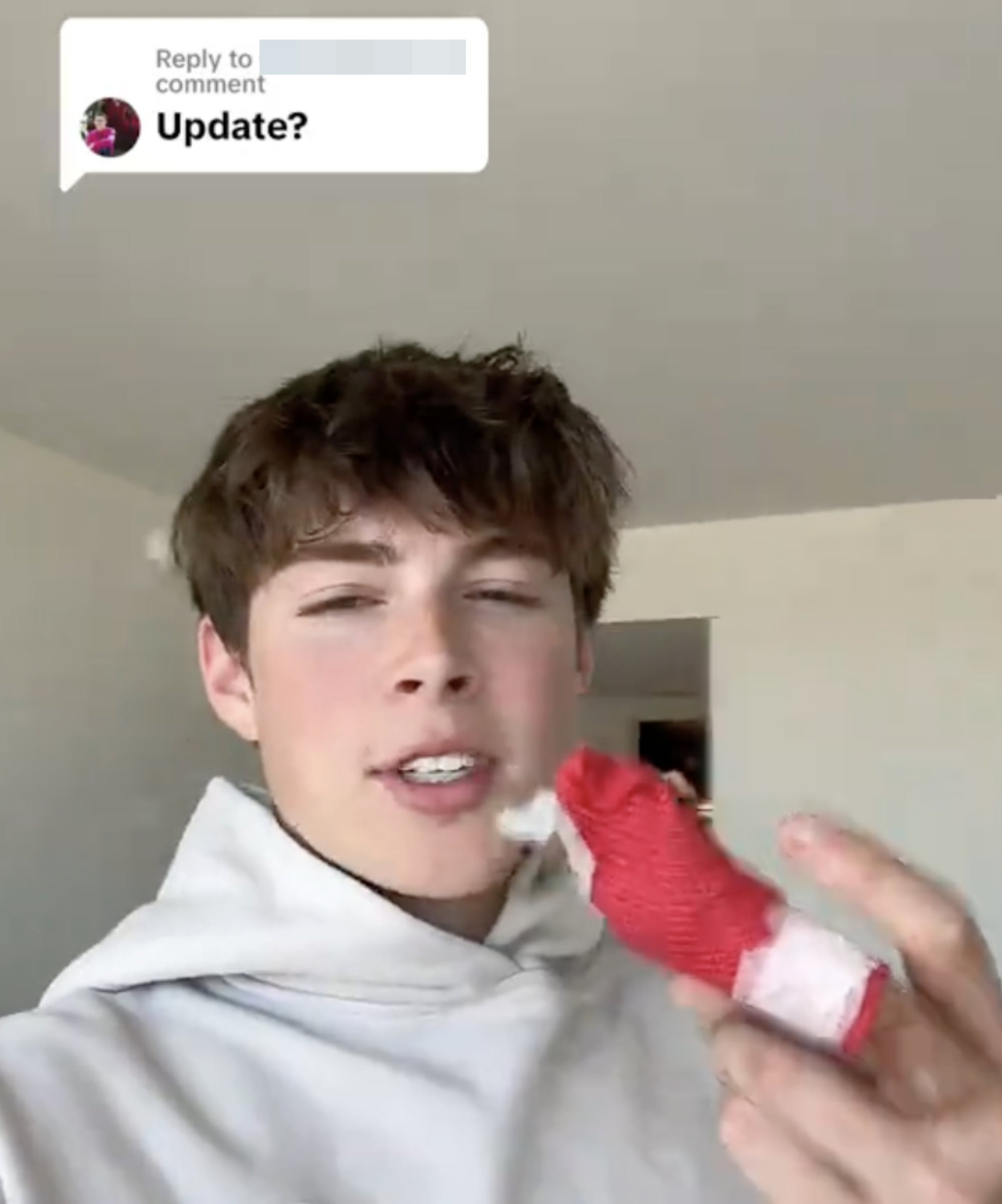Jackson Dean in a hoodie responds to a comment asking for an update holding up a bandaged finger
