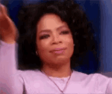 Oprah Winfrey gestures emotionally with her hands outstretched and a tearful expression during a talk show moment