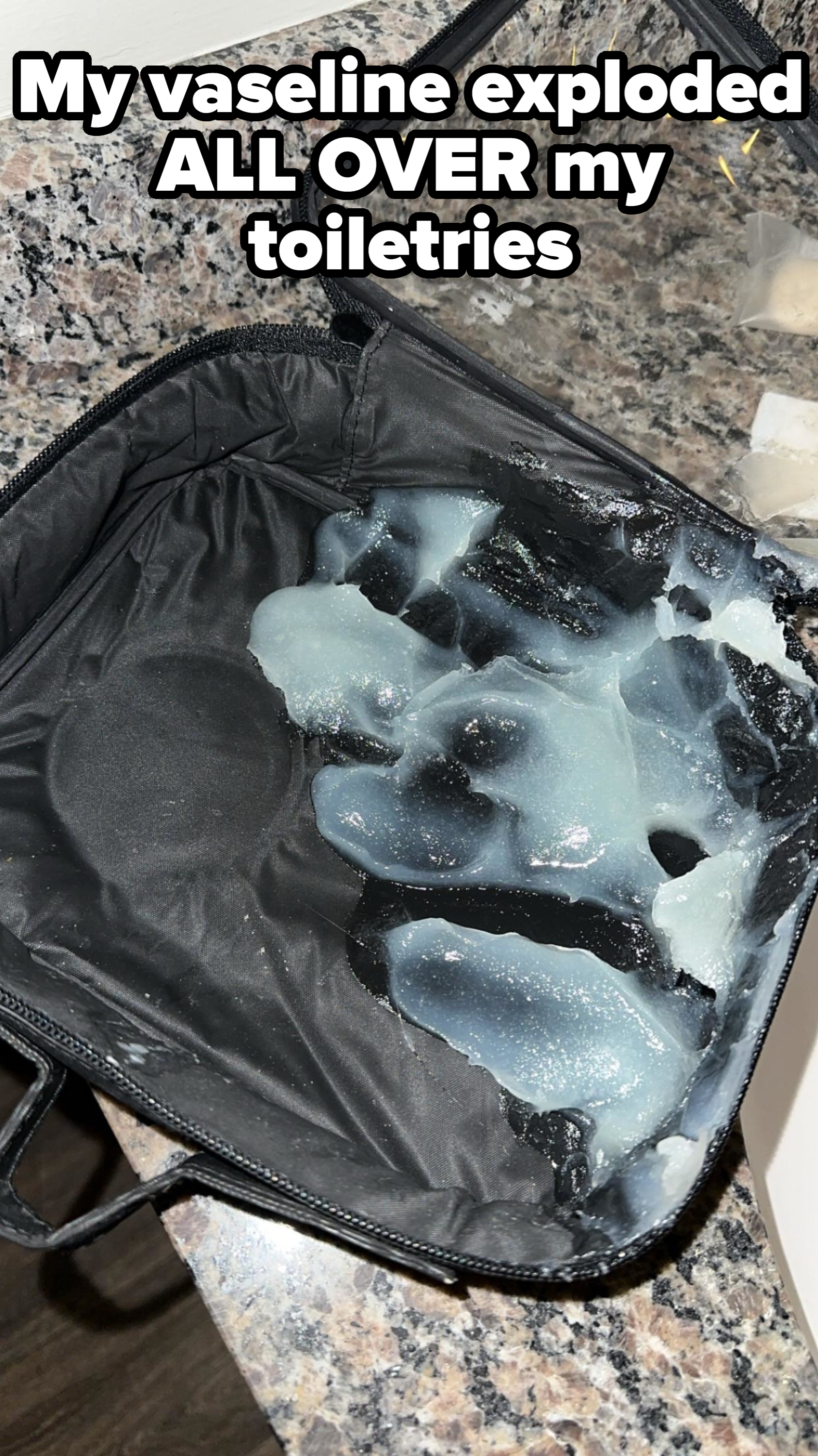 A black makeup bag is opened on a counter, revealing a spilled, semi-translucent liquid or gel inside