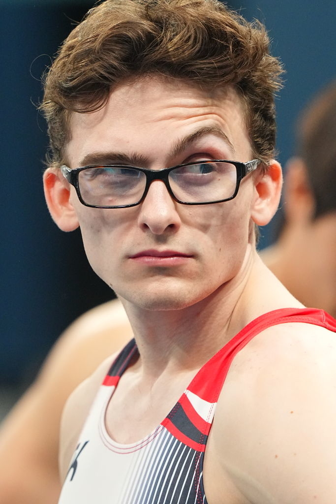 Stephen Nedoroscik is wearing glasses and a sports jersey, looking to his right with a focused expression