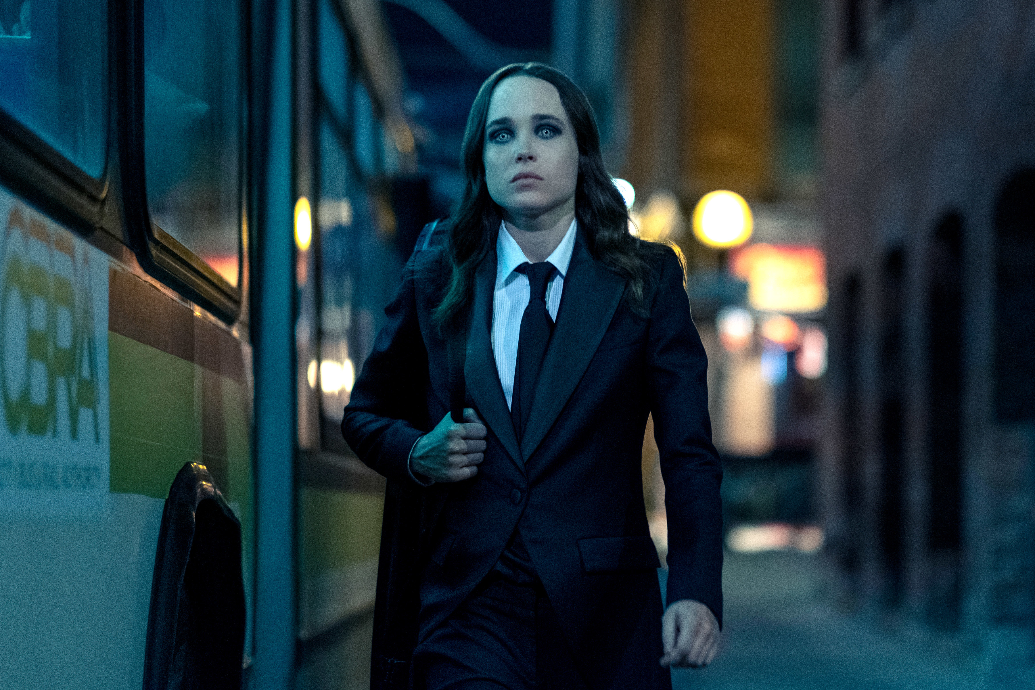 Elliot Page wearing a suit and tie in a scene from "The Umbrella Academy"